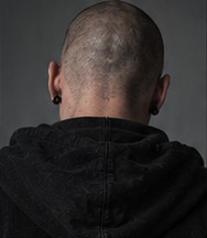 Pulse photographed from behind, wearing a hooded jacket.