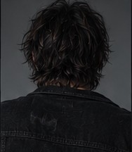 Wire photographed from behind, wearing a worn jacket.